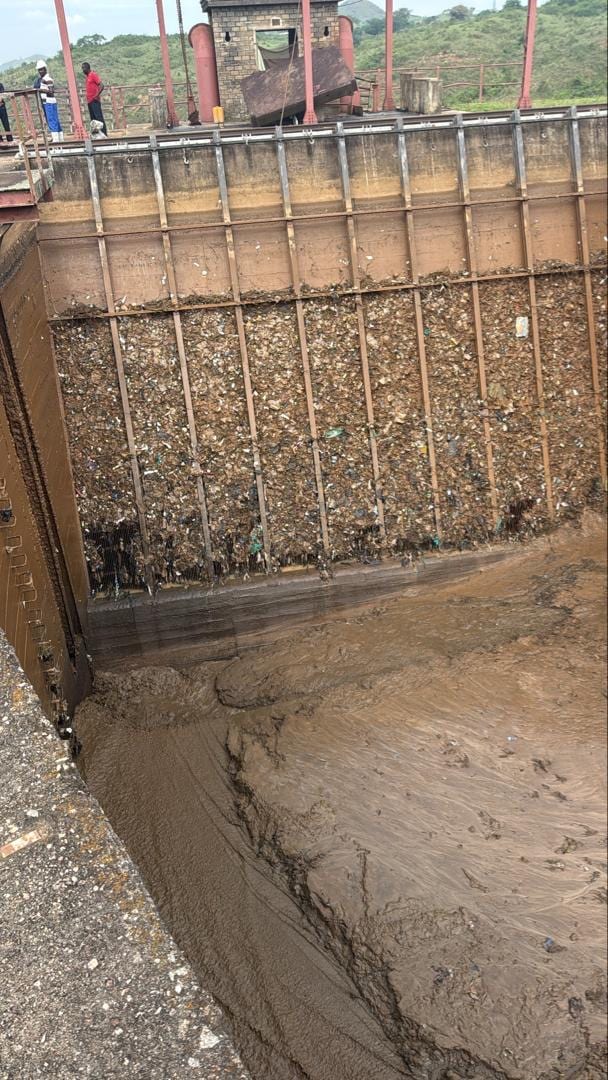 Plastic waste accumulated against the dam
