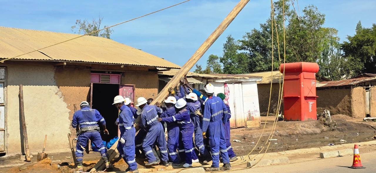 Greentech engineers erecting a new distribution pole in Bunia