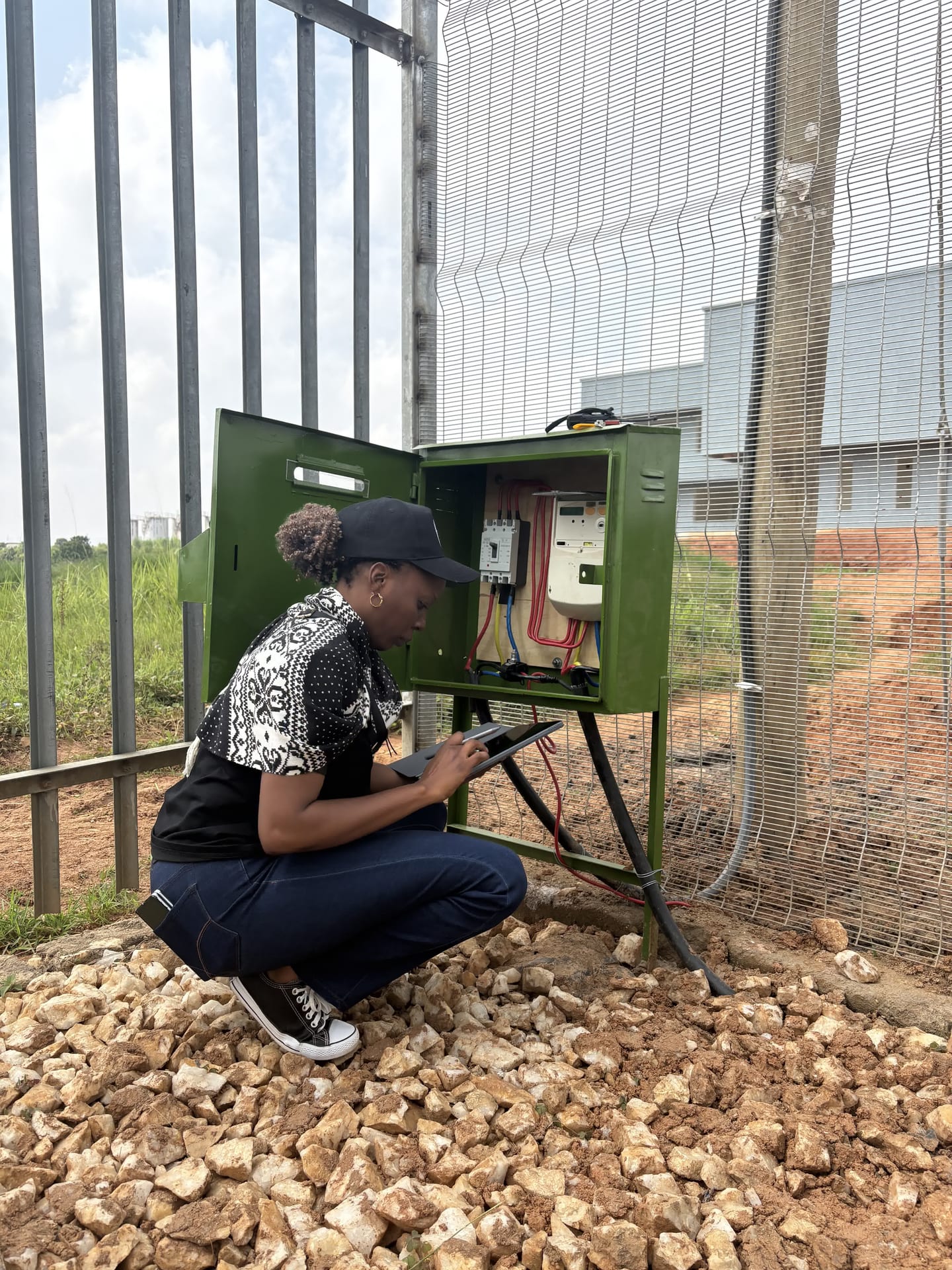 Greentech employee checking the reading on a three-phase meter