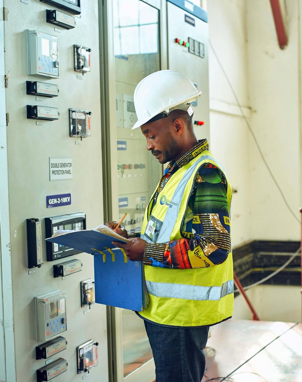 Greentech Energy engineer inspecting generator controls
